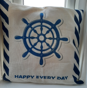 Cushion with a ship's wheel and "Happy Every Day" on it