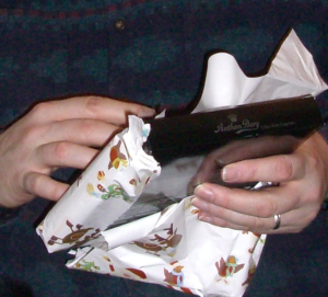Hands unwrapping a present